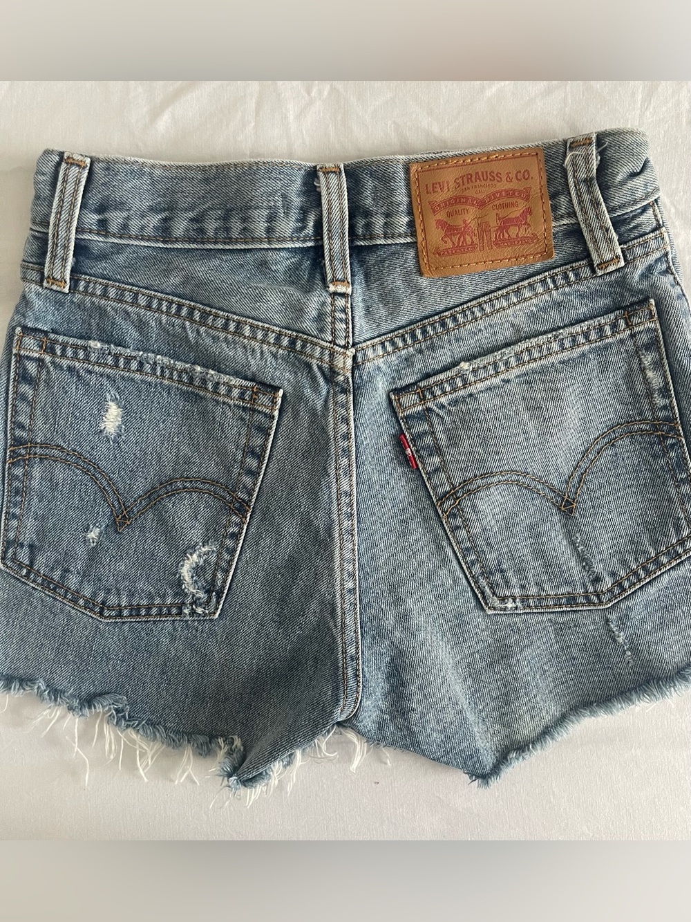 Levi’s High-Rise Distressed Denim Shorts in Light Blue